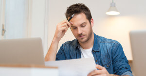 Stressed out dad looking at paperwork